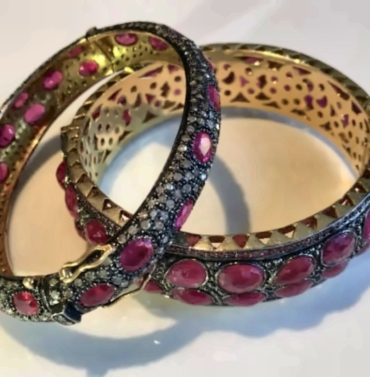 A pair of ruby and rose-cut diamond bangles
